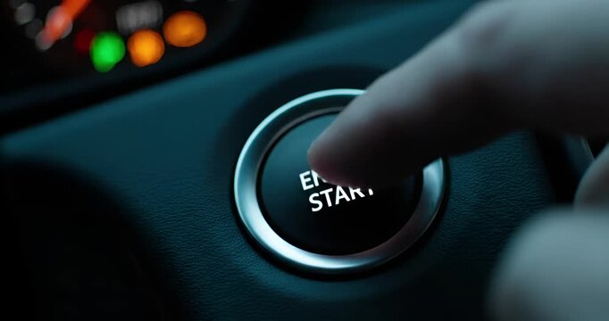 Finger Pressing Car Engine Start Stop Button Ignition Close Up