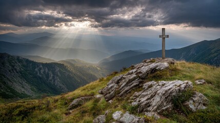 Cross on Mountain Ridge at Sunrise With Rays of Light Shining Through Clouds Creating a Dramatic Scene in Nature