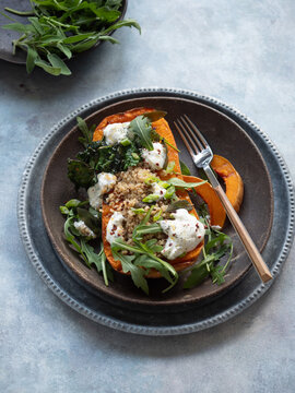Roasted butternut squash stuffed with burrata, quinoa, and arugula