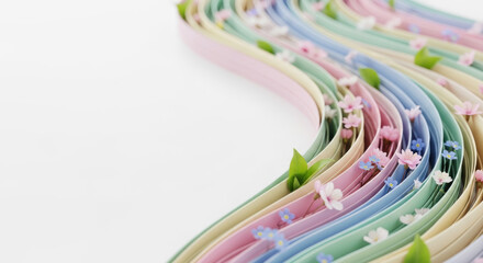 Decorative ribbon with pastel colors and flowers on white surface  