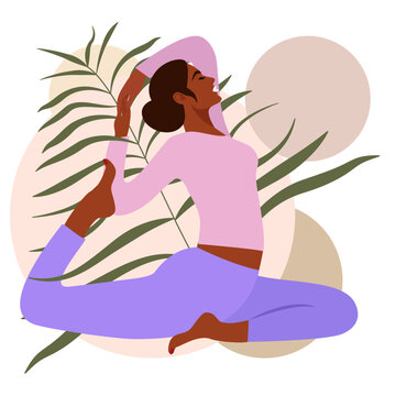 Beautiful black girl with a bun on her head practices yoga in the half-swan dove (Ardha Matsyasana) pose against the background of leaves