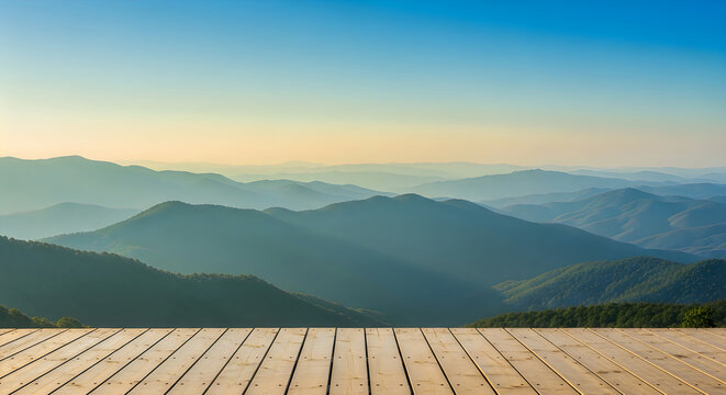 A wooden deck overlooking a mountain range at sunrise