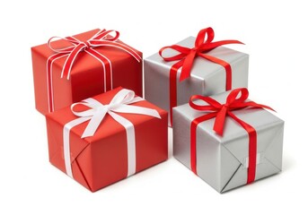 Fototapeta premium Three beautifully wrapped gift boxes with red ribbons ready for holiday celebration.