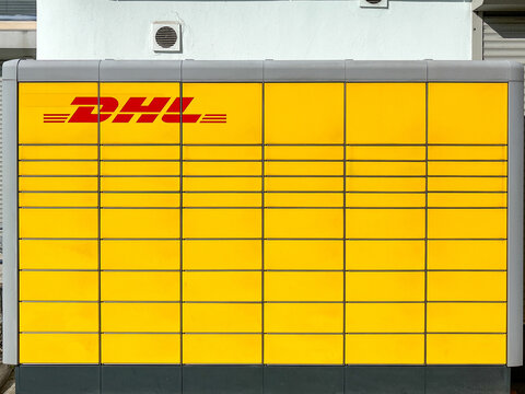 Berlin, Germany - August 16, 2023: DHL Packstation Automated Parcel Locker System for Secure Package Pickup and Delivery Services Yellow Shipping Station Urban Infrastructure