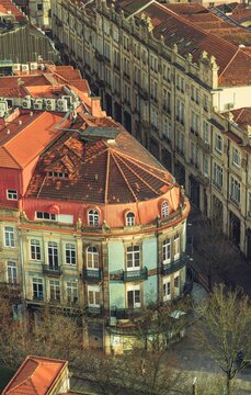Vivid hues of sunset blend with historic buildings in Porto's Ribeira District. Cafes come alive as locals share stories over coffee, embodying the essence of Portuguese saudade