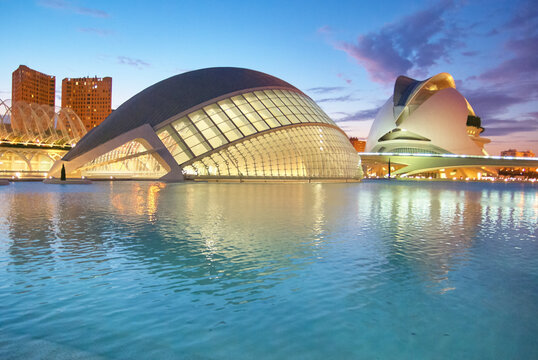 Panoramic view of the illuminated L'Hemisferic and Palau de les Arts Reina Sofia at twilight, City of Arts and Sciences, Valencia, Spain