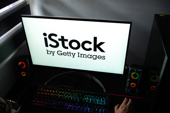 Punta Arenas, Chile &ndash; February 18, 2026: A person at a desk with the iStock by Getty Images stock photography logo displayed on a computer monitor