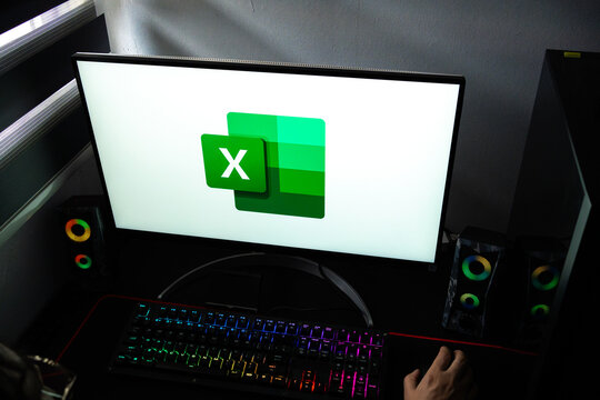 Punta Arenas, Chile &ndash; February 18, 2026: A person at a desk with the Microsoft Excel spreadsheet software logo displayed on a computer monitor