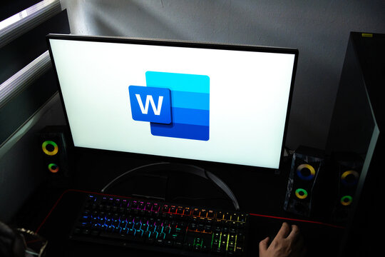 Punta Arenas, Chile &ndash; February 18, 2026: A person at a desk with the Microsoft Word document processing software logo displayed on a computer monitor
