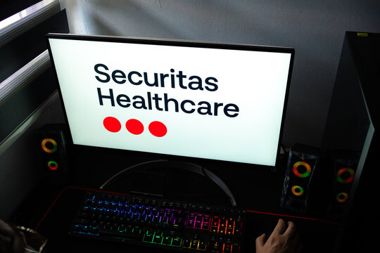 Punta Arenas, Chile &ndash; February 18, 2026: A person at a desk with the Securitas Healthcare medical technology logo displayed on a computer monitor