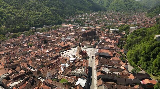 Wide aerial view of medieval square and landmark church framed by vibrant city architecture. Perfect for tourism promotion and heritage visuals