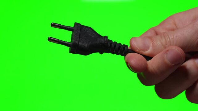 A charging cable for an EA electric appliance against a green background.
An electrical plug against a chroma key background.