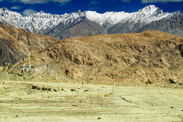 Snowy Himalayan peaks, blue sky at Chang La,southern pass, high mountain pass in Ladakh in the Greater Himalaya between Leh and the Shyok River valley. Leh to Pangong Lake road. Leh, Ladakh, India.