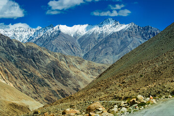 Snowy Himalayan peaks, blue sky at Chang La,southern pass, high mountain pass in Ladakh in the Greater Himalaya between Leh and the Shyok River valley. Leh to Pangong Lake road. Leh, Ladakh, India.