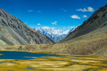 View of lake and river with snowy mountain peak at Chang La , southern pass, a high mountain pass in Ladakh in the Greater Himalaya between Leh and the Shyok River valley. Leh, Ladakh, India.