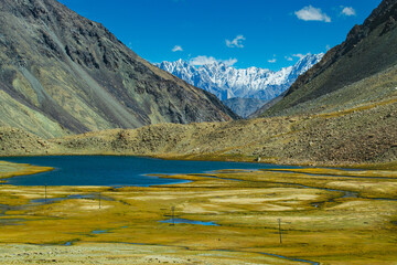 View of lake and river with snowy mountain peak at Chang La , southern pass, a high mountain pass in Ladakh in the Greater Himalaya between Leh and the Shyok River valley. Leh, Ladakh, India.
