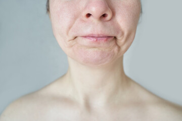 Fototapeta premium Mature caucasian female with natural skin expression against neutral background.
