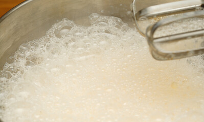 making very thin pancakes with Choux pastry, bubbly lacy texture 
