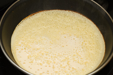 making very thin pancakes with Choux pastry, bubbly lacy texture 
