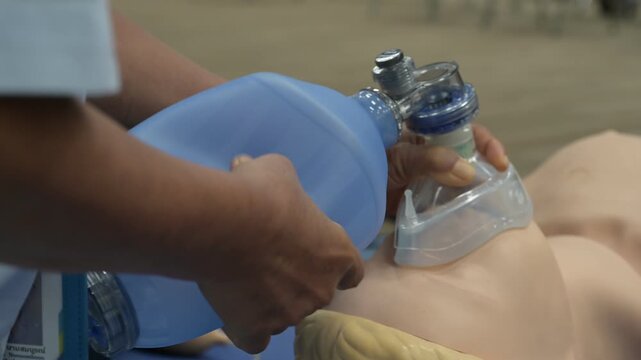 Demonstrating CPR (Cardiopulmonary resuscitation) training medical procedure on CPR doll in the class.Doctor and nurse students are learning how to rescue the patient.First aid for safe life concept.