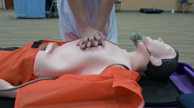 Demonstrating CPR (Cardiopulmonary resuscitation) training medical procedure on CPR doll in the class.Doctor and nurse students are learning how to rescue the patient.First aid for safe life concept.