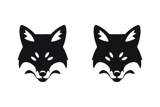 Minimalist black stylized fox heads facing forward with white accents isolated on a transparent background