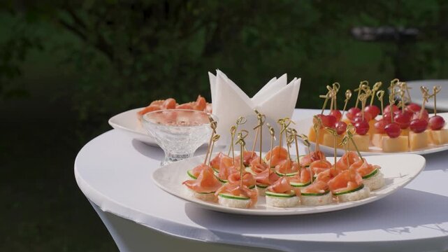 A set buffet table at a celebration, slow-motion camera movement, all sorts of delicious dishes