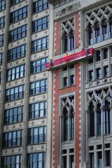 Fototapeta premium Men on Elevated Platform Washing Windows on Skyscraper or Highri