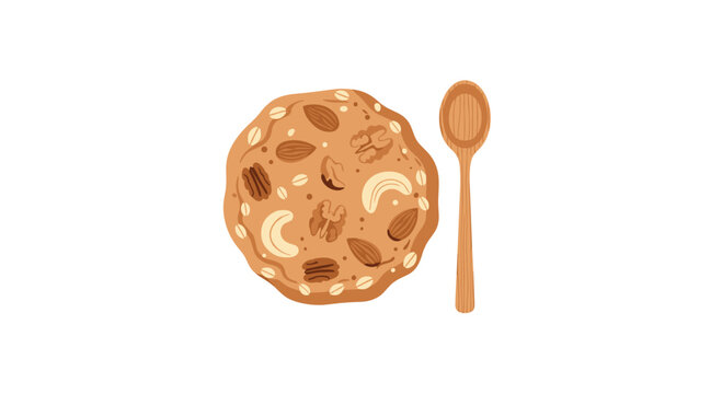 A large, round oatmeal cookie topped with various nuts and grains, positioned next to a simple wooden spoon.