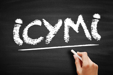 ICYMI text written in chalk on a textured blackboard with a hand holding a chalk stick. Acronym for...