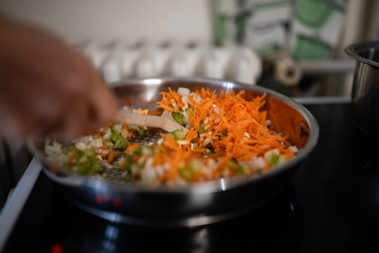 Preparing mirepoix vegetables by saut&eacute;ing carrots celery onions