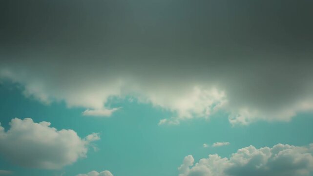 Azure sky dotted with soft white cumulus clouds, wide and tranquil, evoking freedom, openness and peaceful summer airperfect clean background with ample copy space