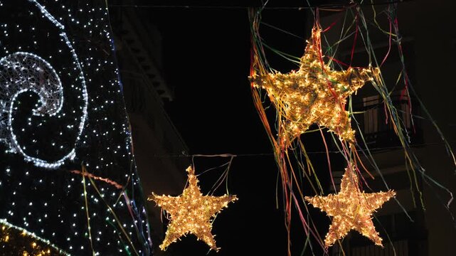 A star-shaped garland glows, christmas tree on the streets of the evening city. The city is decorated with New Year's and Christmas decorations. High quality 4k footage