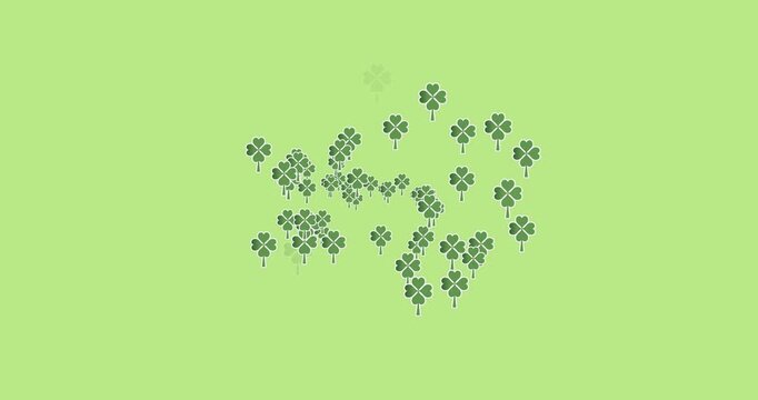 Digital animation of multiple clover leaves forming against green background