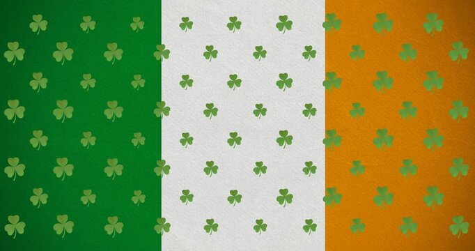 Digital animation of multiple clover leaves moving against irish flag