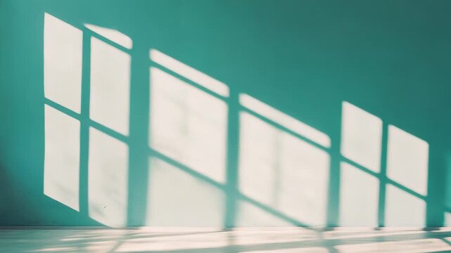 Sunlight slanting through a window casts bold geometric shadows across a teal wall and warm wooden floor, minimalist interior evoking calm, freshness and clean modern simplicity