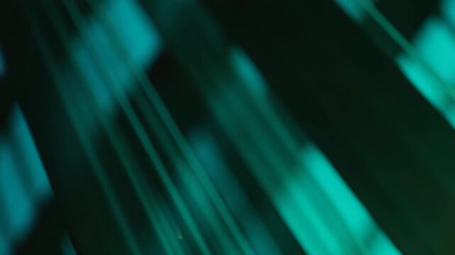 Abstract parallel lines and blurred light reflections create an immersive teal and green background, conveying concepts of technology, data, and futuristic design