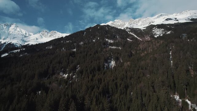 Spain mountain revealed behind fir tree forest with snow covered white winter alpine landscape. Mountain aerial drone view at evening. Travel, tourism concept. Background copyspace forest copy space.