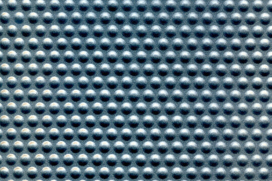 perforated metal gray surface with raised bubbles