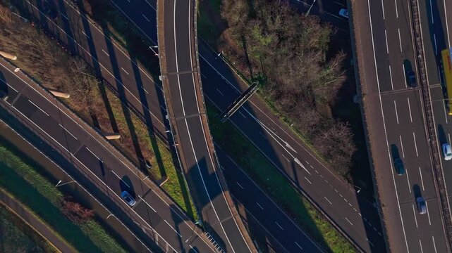 An overhead drone view of fast moving traffic on the Spaghetti Junction M6 motorway in Birmingham, UK