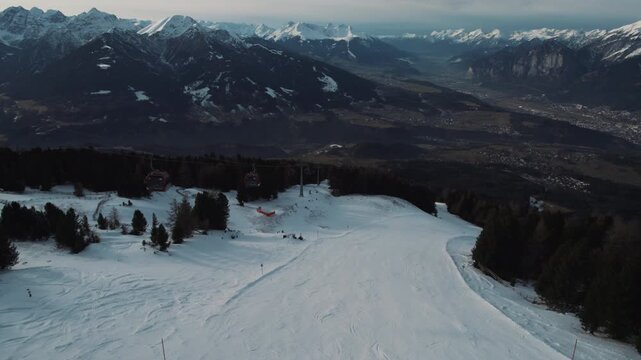 Aerial top view ski turns on a steep ski slope in a glacier ski resort high up in the alps with fresh snow. Panorama skiing with the best mountain landscape is absolute freedom. Cold winter day skiing