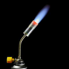 Gas burner flame on a dark background.