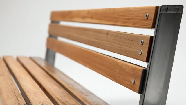 Medium shot of a sturdy urban bench crafted from metal and wood showcasing its durable design ideal for hightraffic public spaces and vandal resistance.