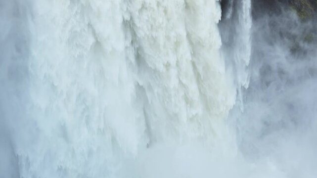 Large waterfall crashing in cascading water as white water falls in layers