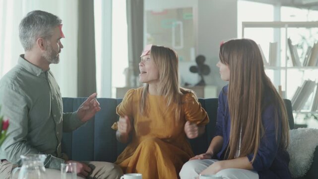 Casual family bonding through silly guessing game, Cheerful family participates in humorous guessing challenge