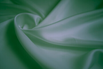 Obraz premium White silk fabric with neon green reflections and elegant swirls