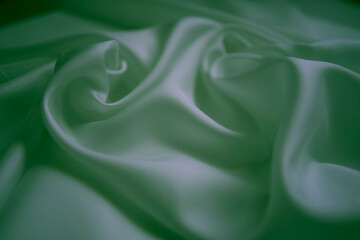 Obraz premium White silk fabric with neon green reflections and elegant swirls