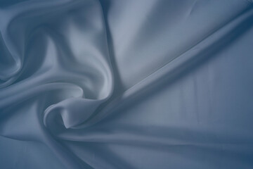 Obraz premium White and cashmere blue silk fabric with elegant flowing folds