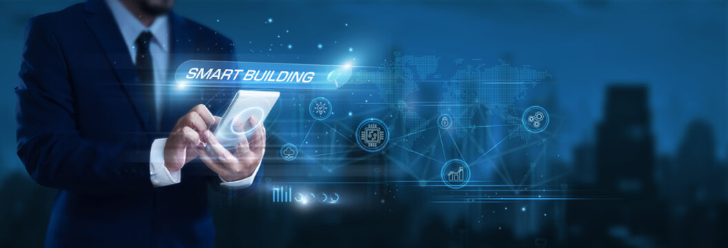 Businessman using smartphone to find and analyze smart building data, IoT automation systems, energy efficiency monitoring, intelligent infrastructure management
