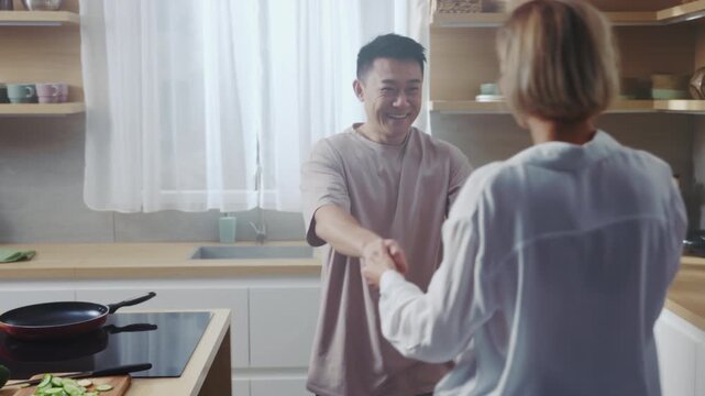 Asian man and woman sharing warm kitchen moment, Loving couple involved in cooking across cozy kitchen counter